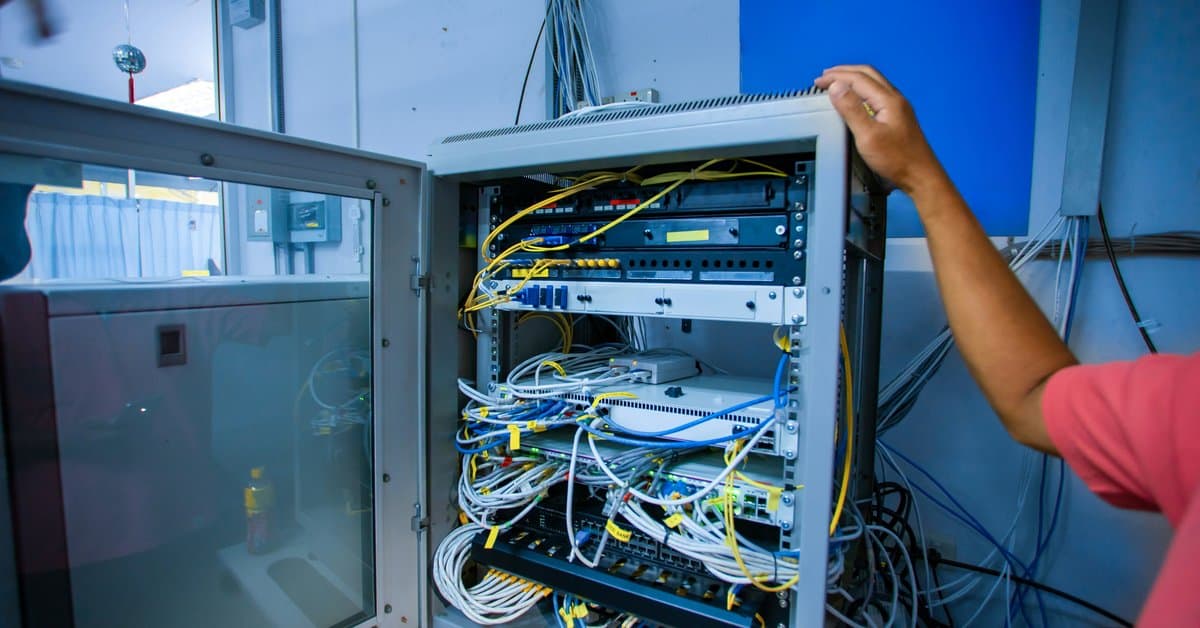 Network cabling MACs Dallas technician activating a spare patch panel port during an office reconfiguration