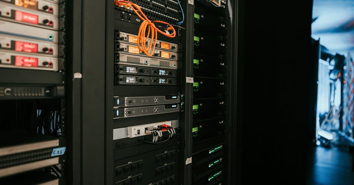 Network rack with patch panels, switches, and servers showing AI server room cabling