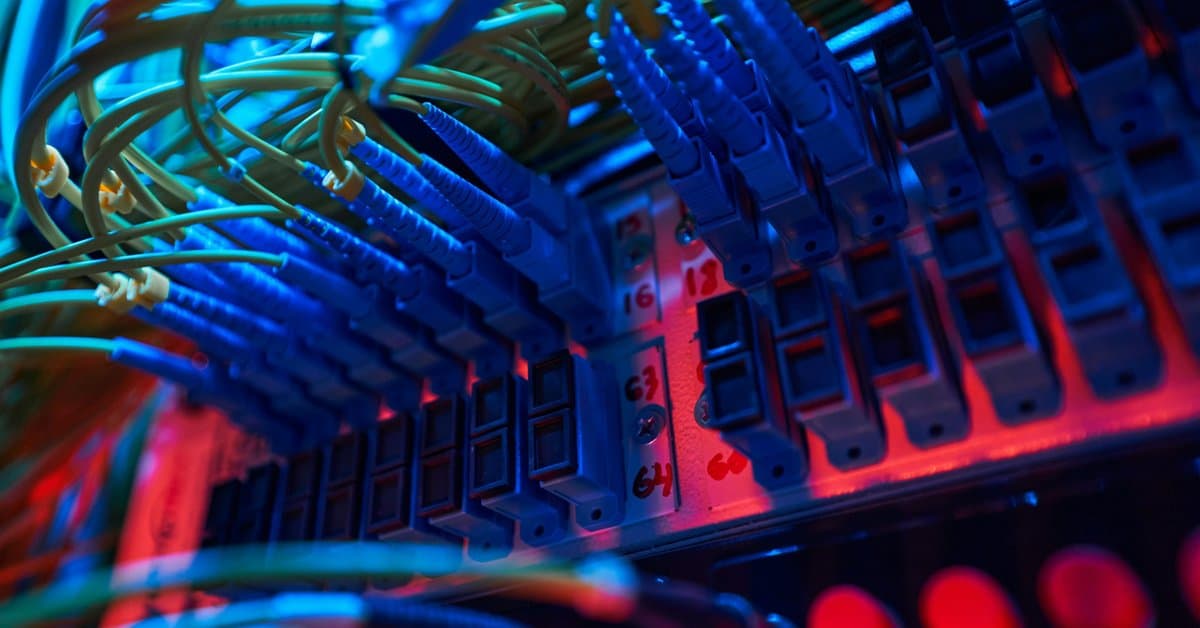 Fiber connectors plugged into a labeled patch panel showing pre-terminated cabling Dallas projects use