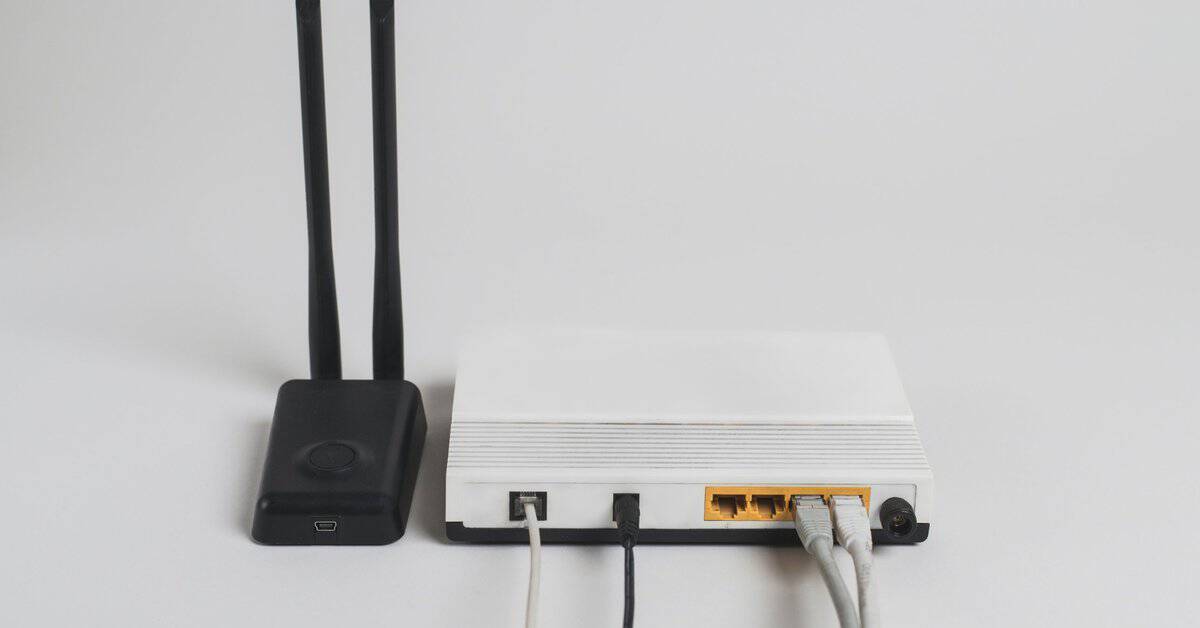 Wireless router with Ethernet cables connected, illustrating Wi-Fi 7 cabling Dallas offices rely on